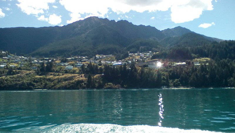 Queenstown village nestled in between mountains and Lake Wakatipu