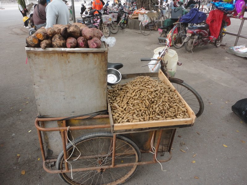 Street vendor selling peanuts and sweet potatoe 
