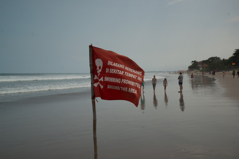 Swimming prohibited flags on the beach near Kuta