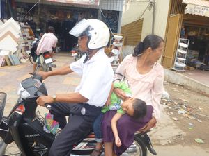 27 Tough being a kid in Cambodia. No child seats around here.