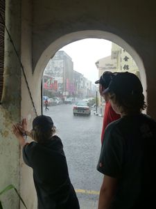 36 Taking cover during a down pour in George Town