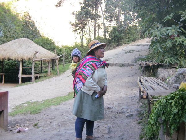Peruvian lady and baby on trail