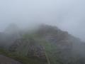 Machu Picchu starts to appear through the clouds