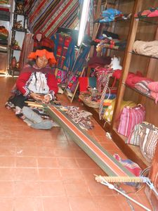 Woman weaving in her store