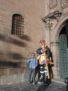 Posing with a statue near the cathedral in Cusco