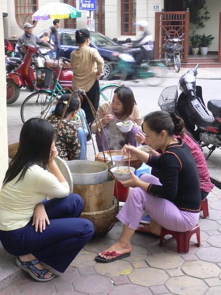 Women eating from vendors on the street