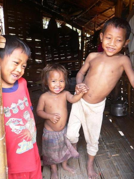 Cute happy village children in their house 