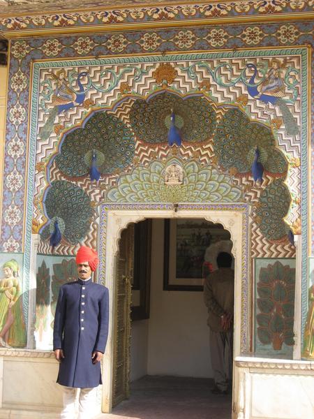 A guard by the Peacock Gate at the City Palace