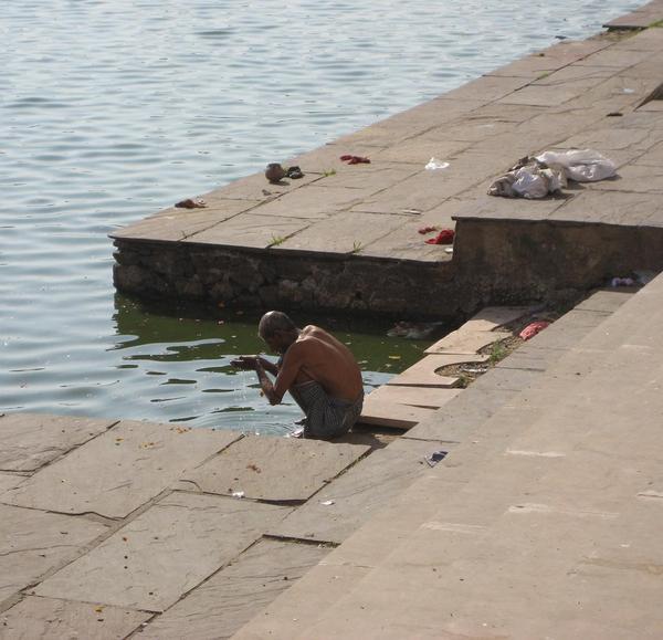 A man bathing and praying