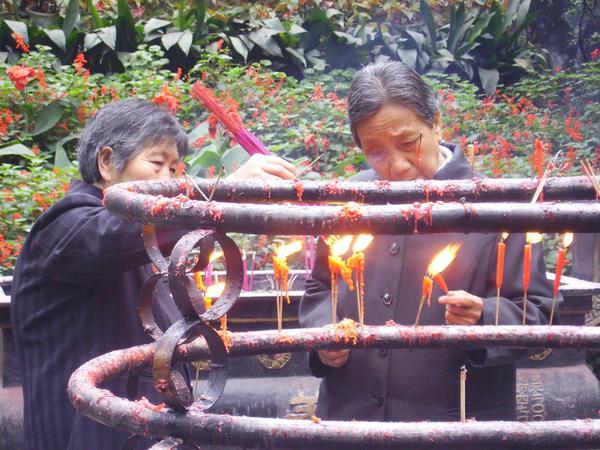 two friends lighting incense and candles