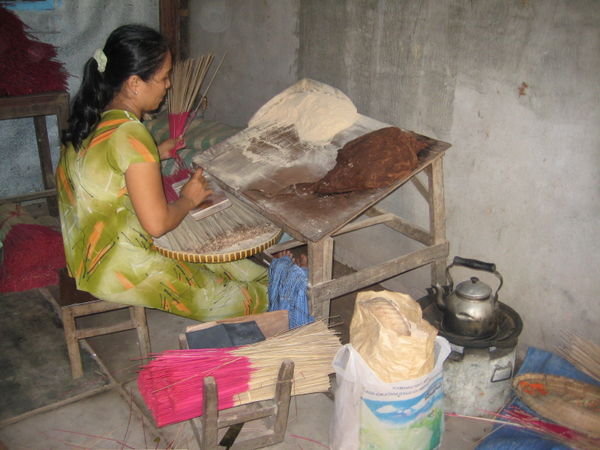 woman making incense sticks