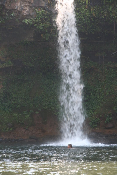 Ash swimming at the base of a waterfall