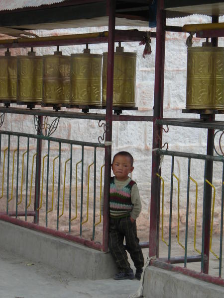 Tibetan boy and prayer wheel