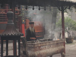 Man preparing insence at the Taoist Temple