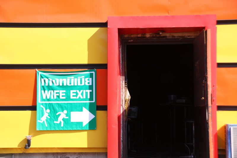 sign on the exit door of a club near bus station