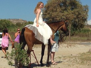 Bride arriving on horseback, led by Dad