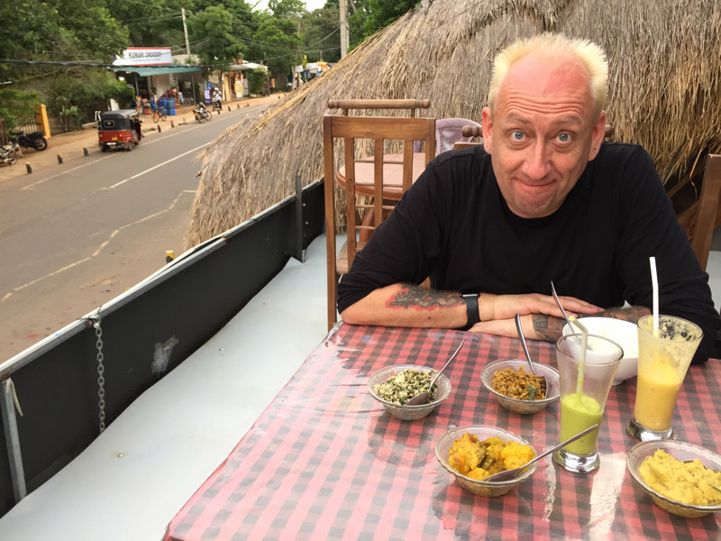 Hubby on rooftop restaurant, eating Sri Lankan curry