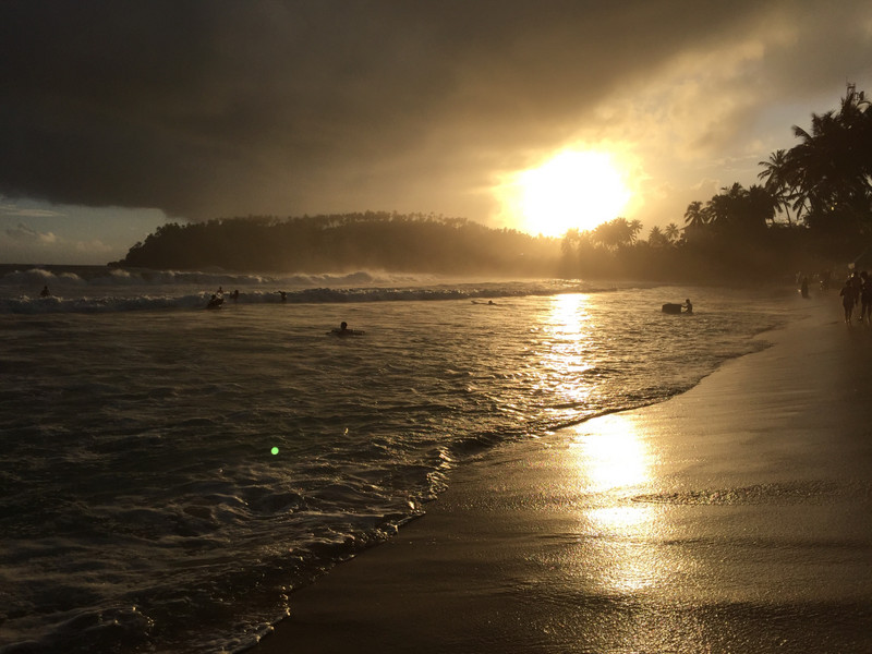 Sunset and surfers at Mirissa