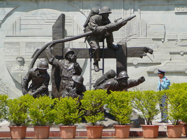 Policeman admires the monument to firefighters
