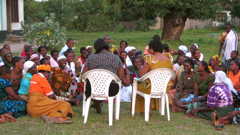 Maguy speaking and praying with the women in the community.