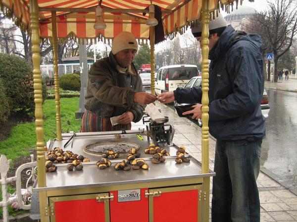 Michael buying roasted chestnuts from a street vender in Istanbul