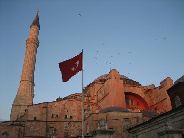 The Aya Sofya at sunset with Turkish flag