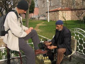 Colin having his shoes cleaned between the mosques in Istanbul