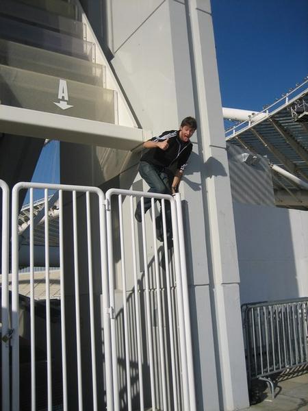 Joel scaling the gate on the way out of the Stadium