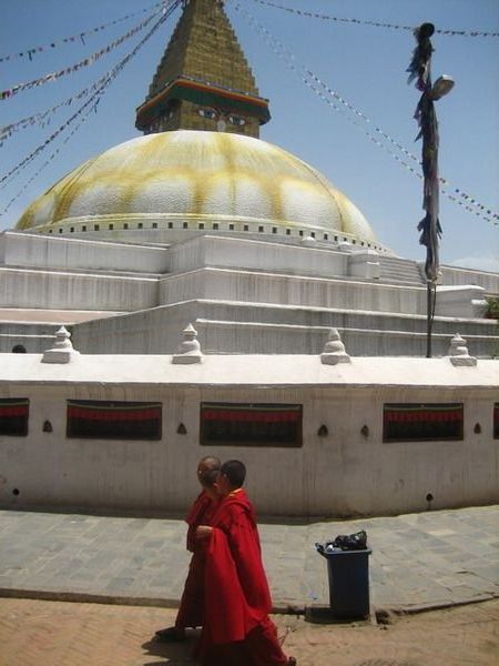 Tibetan monks walk around the Bouddhanath Stupa