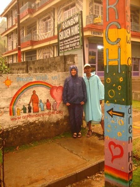 Standing in the rain outside the Rainbow Childen Home in Pokhara