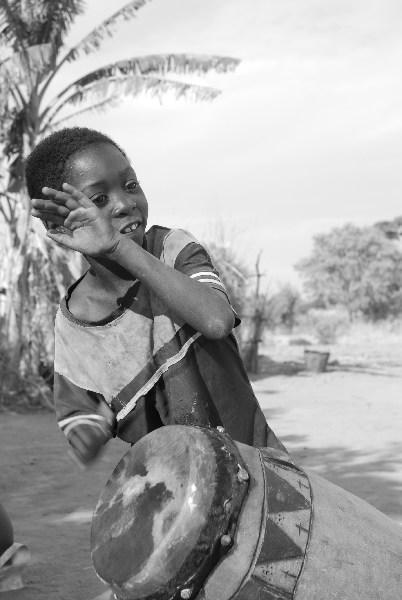 Kid playing drum, Zambia