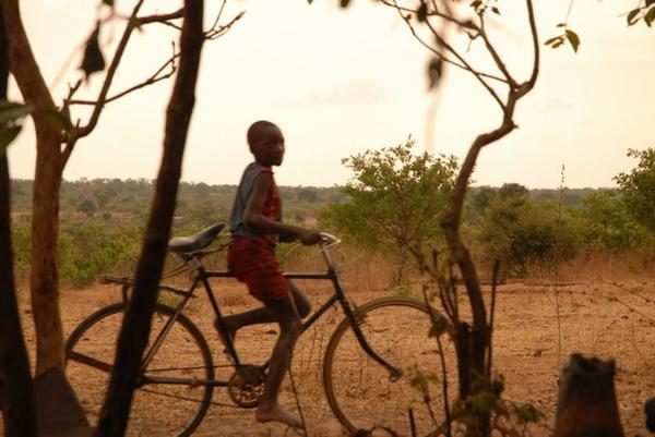 Boy on bike in Zambian village