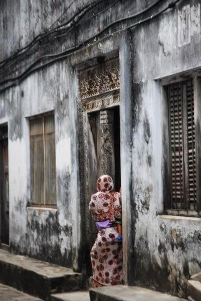 Woman at door step · Stone Town, Zanzibar