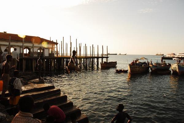 Kids jumping in the water at sunset · Harbor in Stone Town, Zanzibar