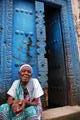 Old woman in front of blue door · Stone Town, Zanzibar
