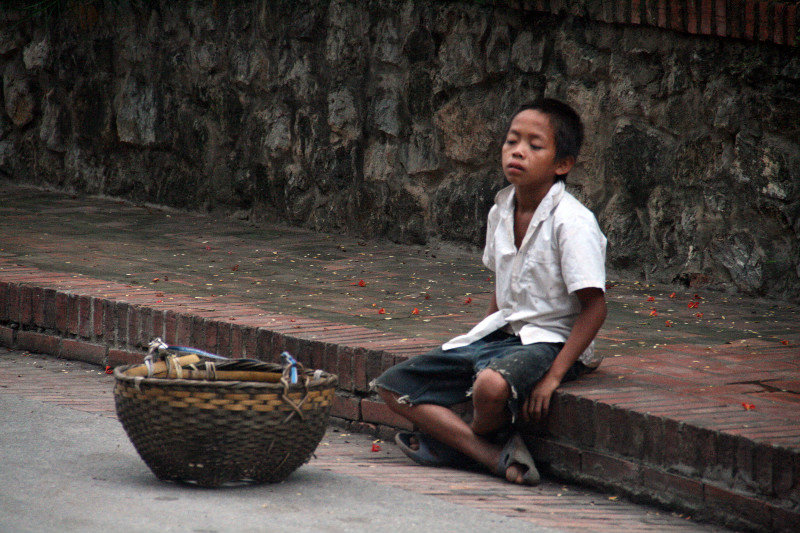 little boy waiting for some gifts from the monks
