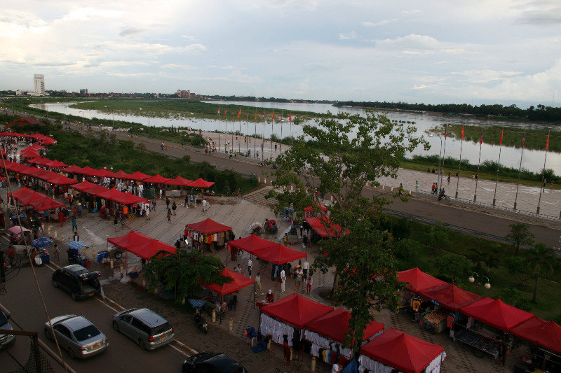 night market setting up by the Mekong