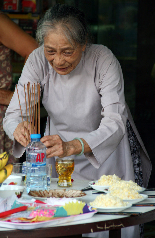 lovely old lady preparing offerings