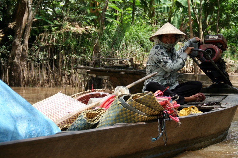 passing by vendors while cruising on the Mekong Delta canals