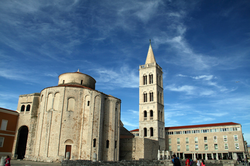 The Church of St. Donatus and the Cathedral's Bell Tower under a painted sky
