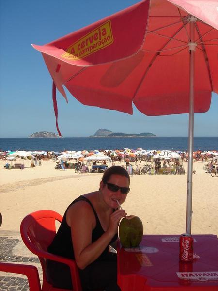 Kez sipping an agua de coco on Copacabana beach