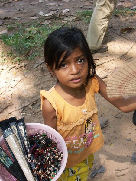 Little girl trying to sell us a sented fan