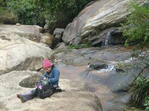 Anh sitting on the waterfall