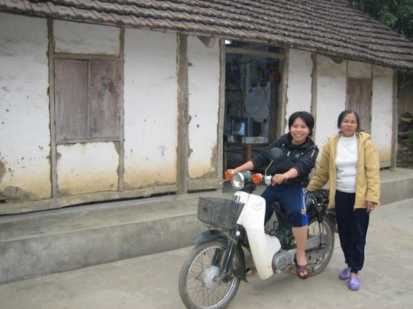 Anh, mom, motorbike and house
