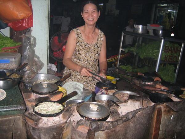 Woman making Hue style pancakes