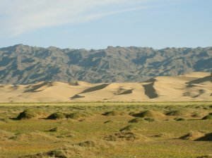 Blue mountains, yellow dunes, green plains