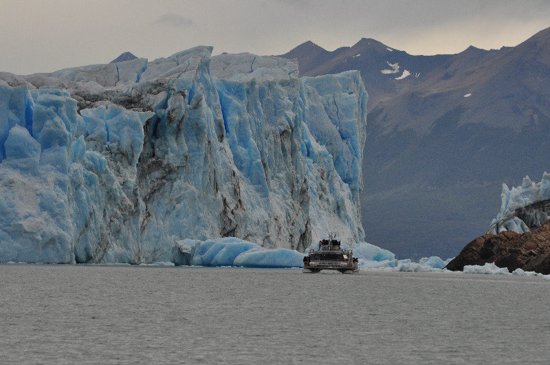 A boat being dwarfed at the glacier face