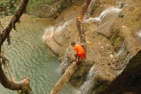 A young monk getting ready to jump