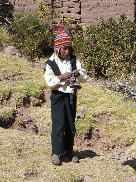 Boy knitting on Isla Taquile