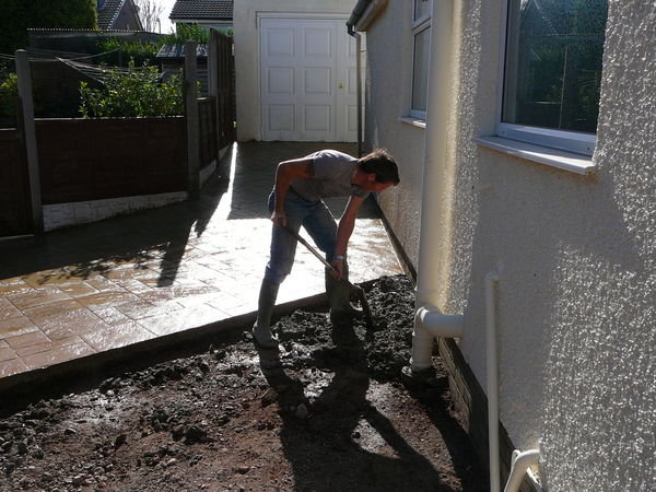 Andy shovelling concrete